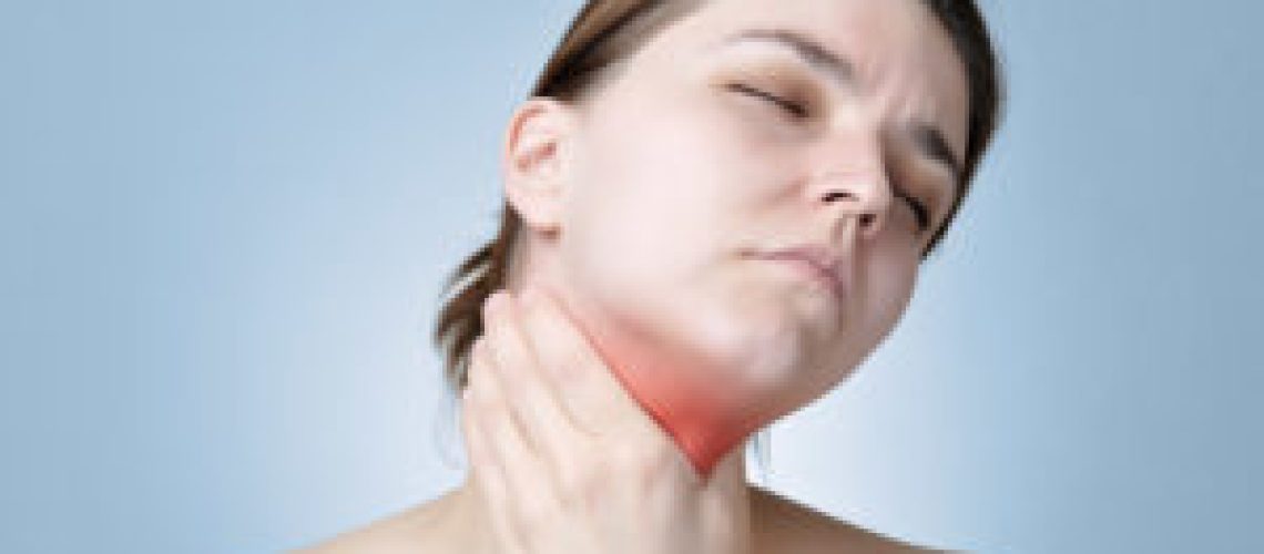 Young woman holding her painful neck